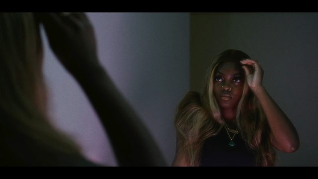 Moody indoor portfolio still with cinematic framing